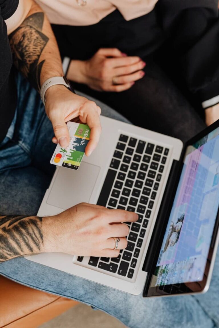 A user pays with a card for online shopping as the result of a Google PPC shopping ad